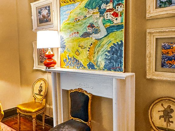 Parlor with decorative fireplace.