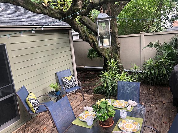 Outdoor dining set in small landscaped yard