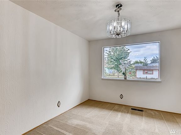 The formal dining room with an oversized window looking out to the backyard.