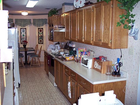 Galley kitchen with breakfast area at end...also side entry