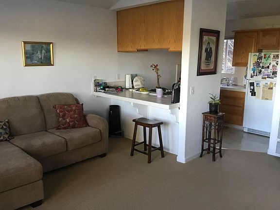 living room toward kitchen has vaulted ceiling