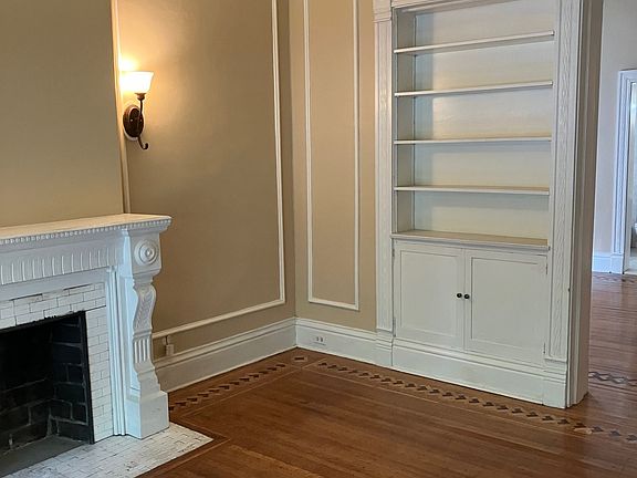 living room bookcase, passage to bedroom on right
