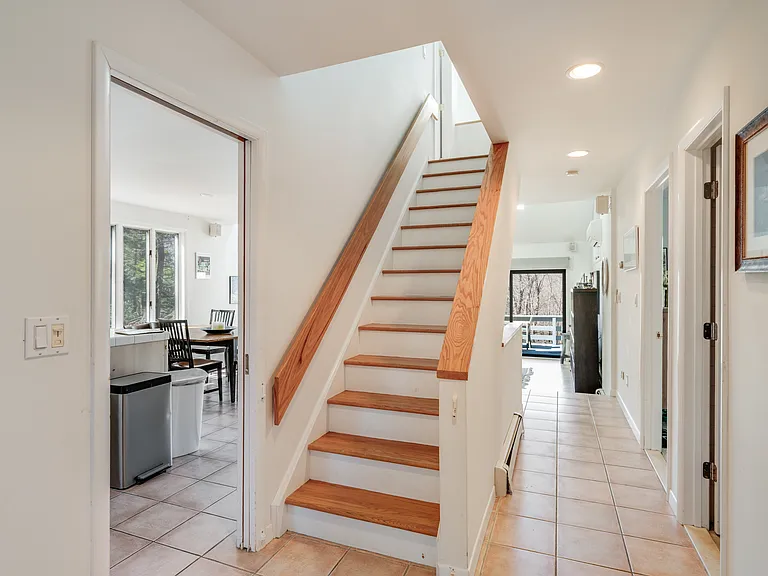 To the upper level with 2 bedrooms and full bath.