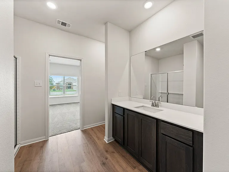 The master bathroom has a large vanity space.