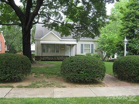 Great front porch for watching the world go by in the shade of the trees. Brick floor.