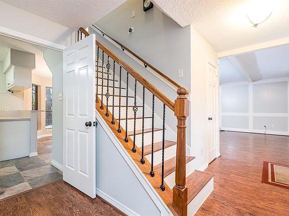 You will enjoy this beautiful wood staircase with wrought iron balusters.