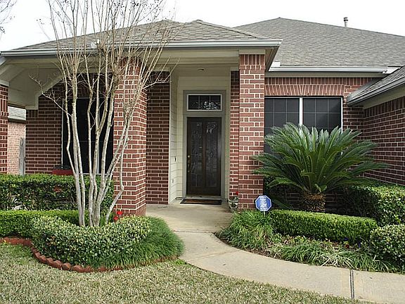 3 sides brick with covered front and back porches.
