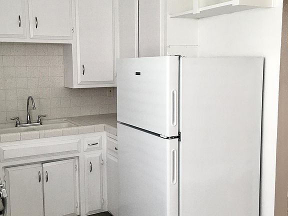 Kitchen with stove and refrigerator