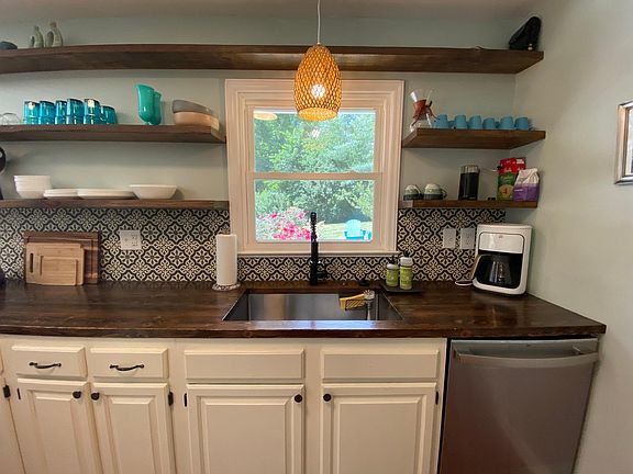 The fully-equipped galley kitchen faces the sunny backyard.