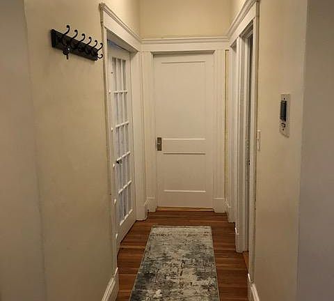 Hallway - One larger bedroom at the end, a smaller bedroom on the left, Kitchen and bathroom on the right