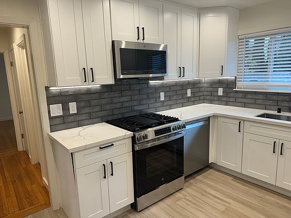 Kitchen with gas stove, microwave/vented hood, dishwasher. All new!