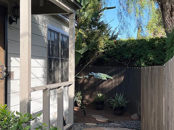 Front of house... gate is on the right and side yard is on the left