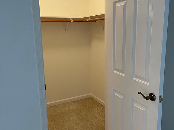 Primary bedroom walk in closet.