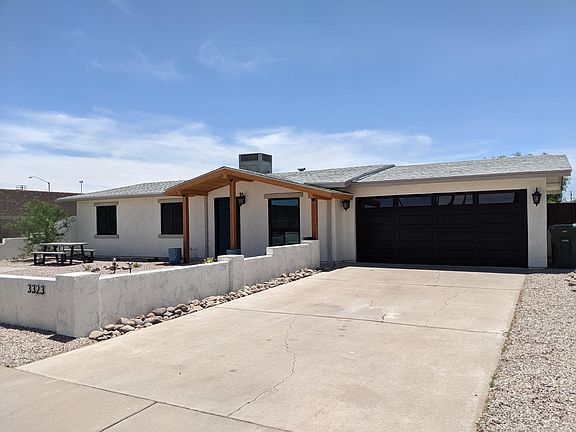 Extra long driveway leads to a two-car garage.