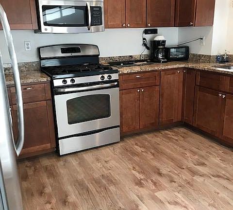 Kitchen. Kitchen has a gas stove, microwave, dishwasher and refrigerator.