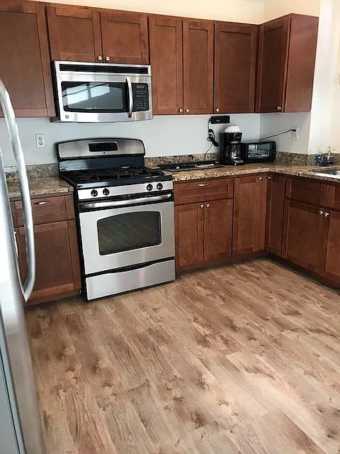 Kitchen. Kitchen has a gas stove, microwave, dishwasher and refrigerator.