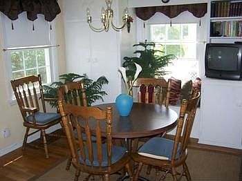Dining room with built in shelving and hardwood floors.