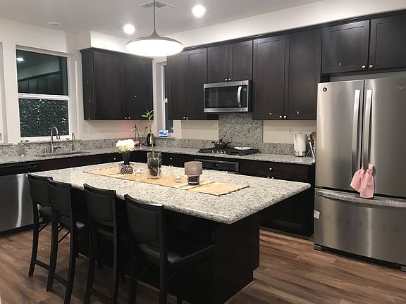 Kitchen view from stair entrance. All the equipments are stainless steel new appliances. There is a pantry room for large storage.