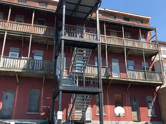 rear of the building with parking and view of the canal