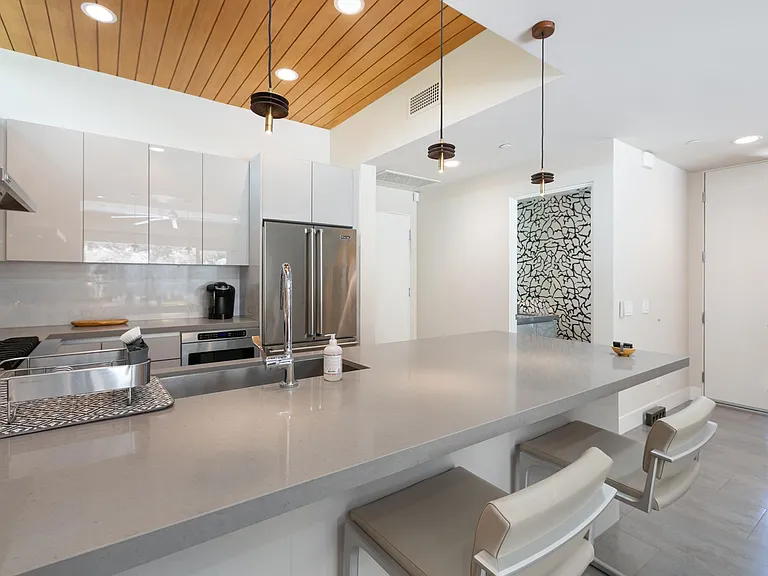 Kitchen with view to front door and first floor powder room.
