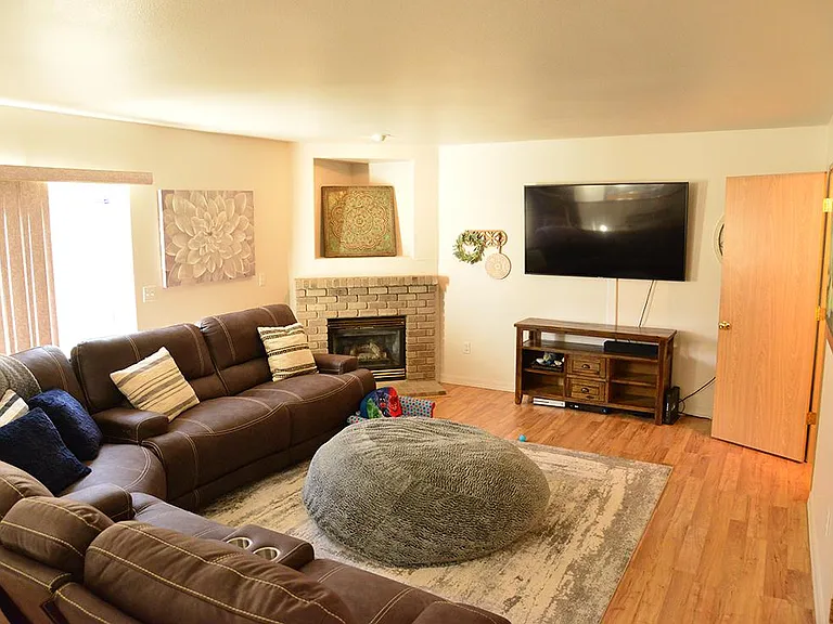 Family room with furniture ,gas fireplace, slider to patio
