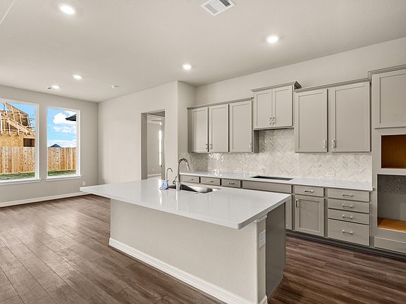 Kitchen open to breakfast area. Note Sample product photo - actual exterior and interior selections