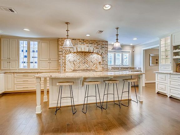 Oversized island can fit at least 6 barstools.