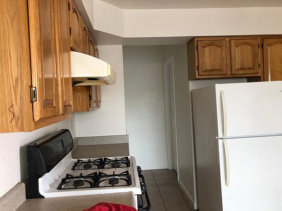 Stove and hallway to bathroom bathroom