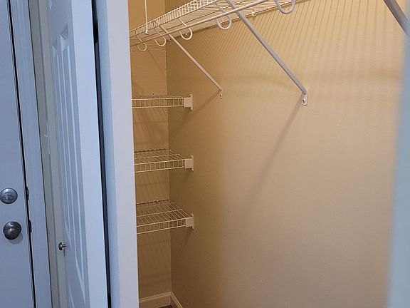 Large double-door hall closet with wire racks