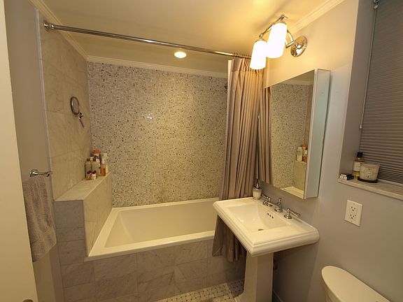 Bathroom with mosaic tile, Zuma soaking tub and wall mounted flatscreen TV
