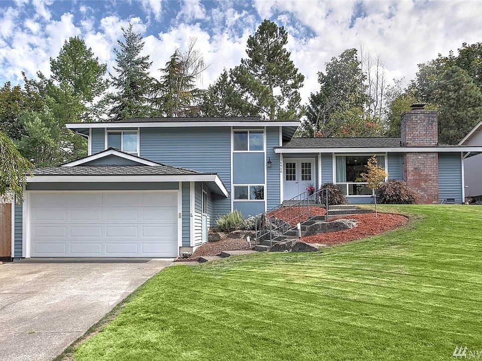 Welcome Home to Fairwood Greens and this wonderfully  updated 4 bedroom tri-level home. As you enter, you'll see it is made for gatherings! You'll be drawn into the expansive open-concept main floor that unites the spacious living room and chef's dream kitchen with soaring vaulted ceilings accented with a gorgeous wood beam. The fantastic kitchen remodel features a sprawling copper surround island, gorgeous quartz counters, stainless steel appliances and an ultra-functional layout. Extend your living and entertaining space outside to the spacious back yard with two large decks, and a hot tub. Enjoy the convenience of the gas hook up for your barbeque and fresh fruit from the pear and apple trees. Upstairs the spacious master features a newly remodeled ensuite 3/4 bath and walk-in closet, along with two additional guestrooms and another gorgeous and fully remodeled full bath. 