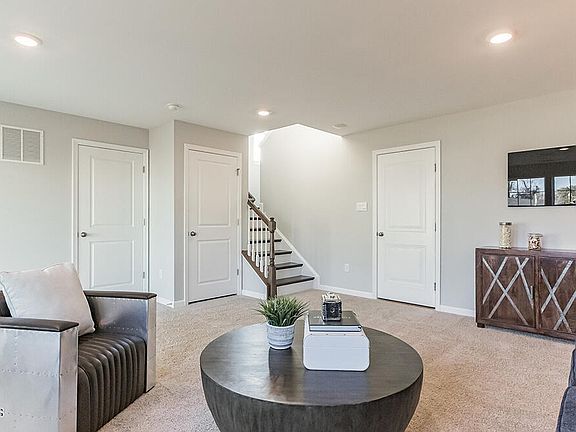 Downstairs family/recreation room with sliders to the outdoors - view is to wooded area