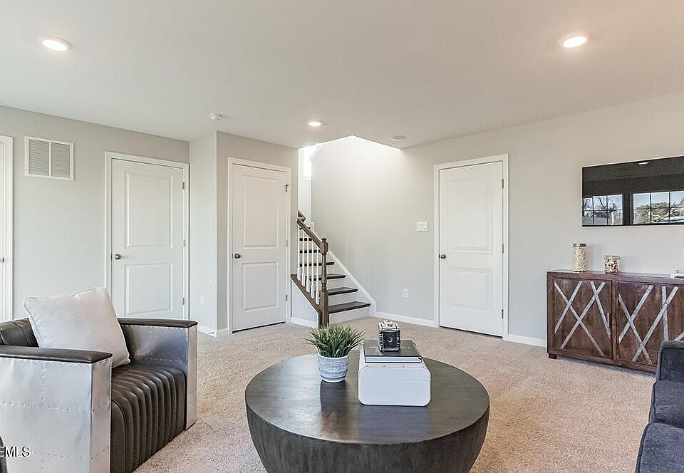 Downstairs family/recreation room with sliders to the outdoors - view is to wooded area