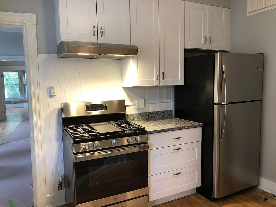 Kitchen with new stainless steel gas range & refrigerator