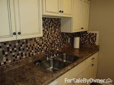 KITCHEN : DOUBLE STAINLESS STEEL SINK, BACK SPLASH TILE AND CREAM WASHED CABNETS
