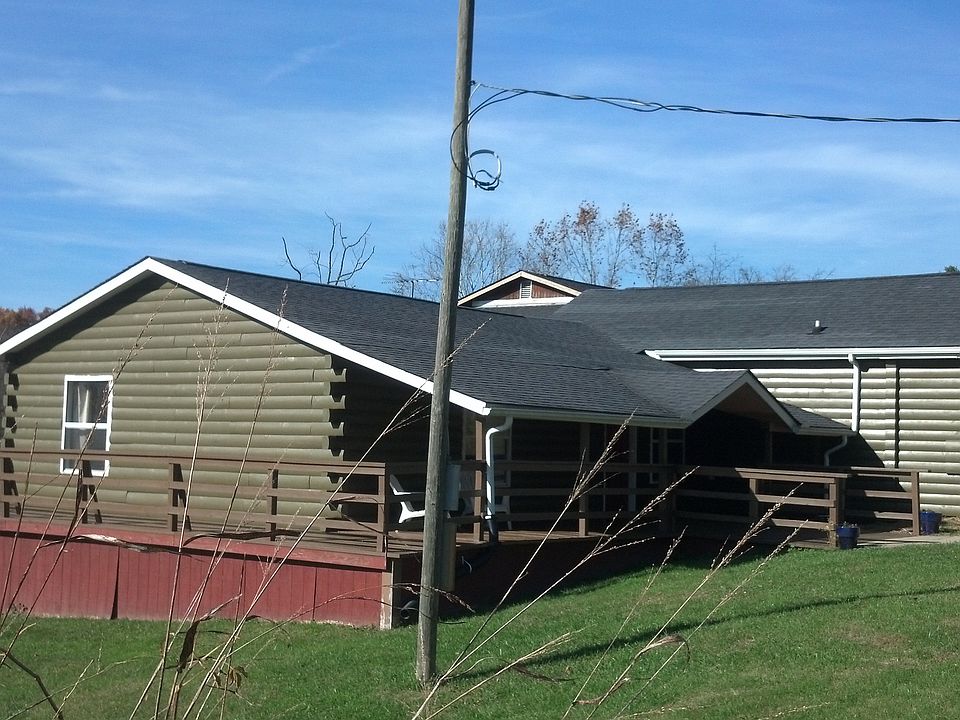 Newly painted log home with wrap around deck