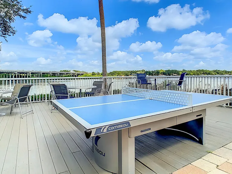 Engage in a game of ping pong or unwind while enjoying refreshments on the outdoor deck, an extension of the oversized pool deck.