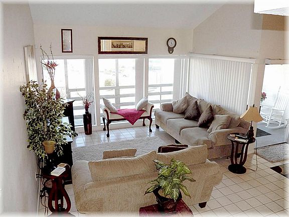view of living room from stairs that go up to 2 bedrooms, bath & large landing sitting area.
