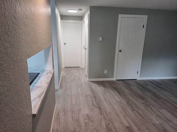 View from front door looking into hall leading to bathroom and two bedrooms.