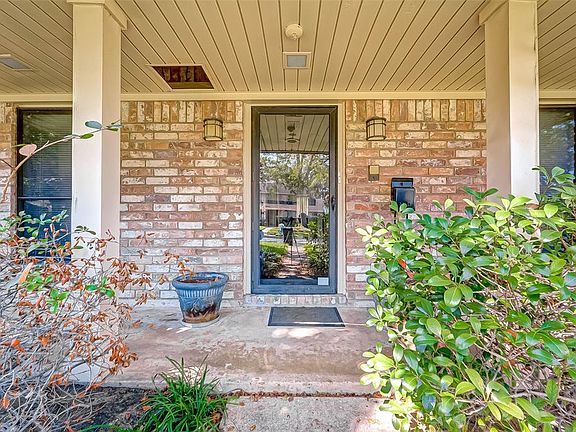 Large front porch with a beautiful storm door that leads you into the home.