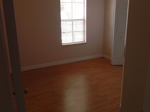 Bedroom one with wood flooring