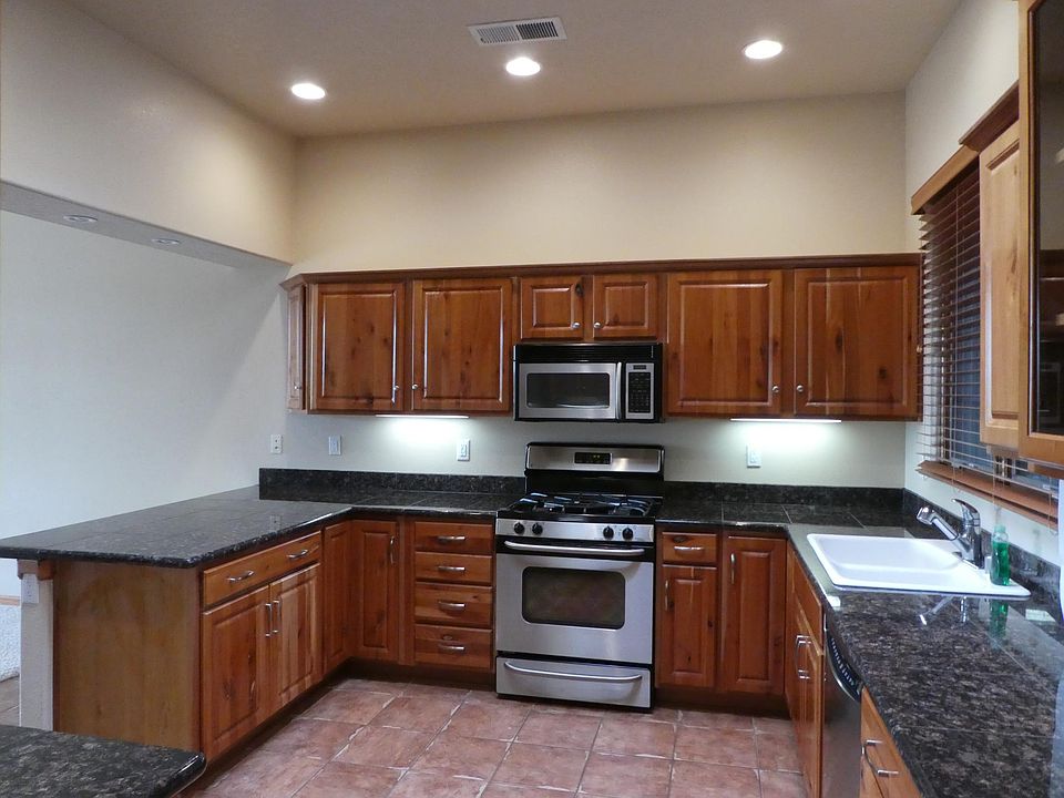 Kitchen features stainless steel appliances including dishwasher, gas range/oven, microwave and side-by-side refrigerator.