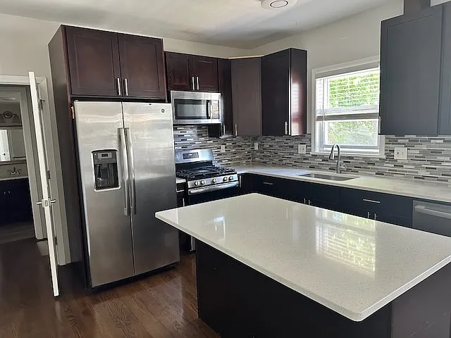 Kitchen/Dining space with stainless steel appliances, island, and soft close cabinets