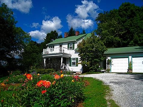 Front with gardens and view