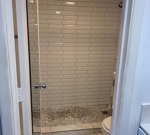 Updated bath with walk in tile shower.