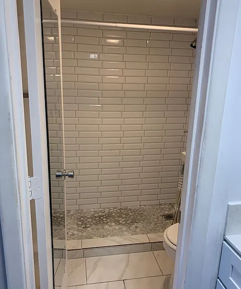 Updated bath with walk in tile shower.