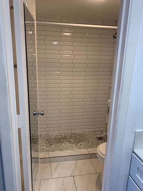 Updated bath with walk in tile shower.