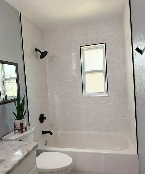 Newly tiled shower with upgraded finishes.
