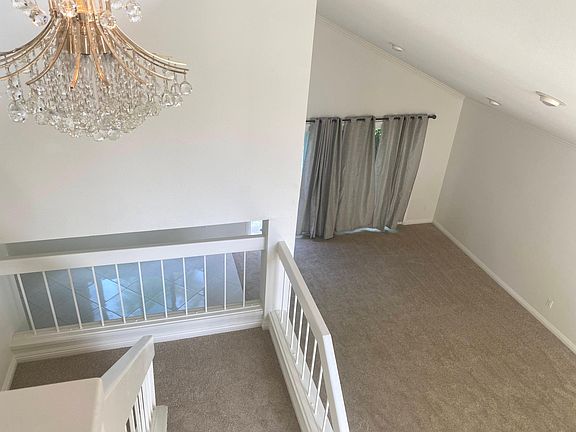 The staircase overlooks the family room and formal dining room
