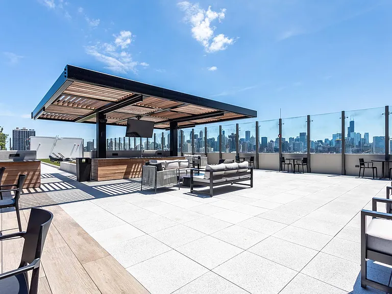 Soak up the sun on the rooftop patio, a spacious area designed for relaxation with stunning views and plenty of room to unwind.